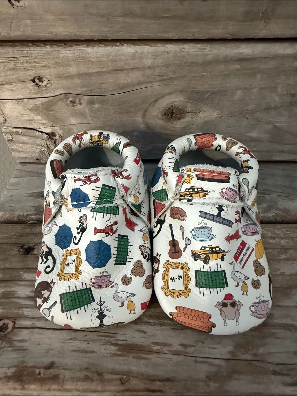 Freshly Picked “Friends” White Baby Moccasins with Multicolor Home Icons